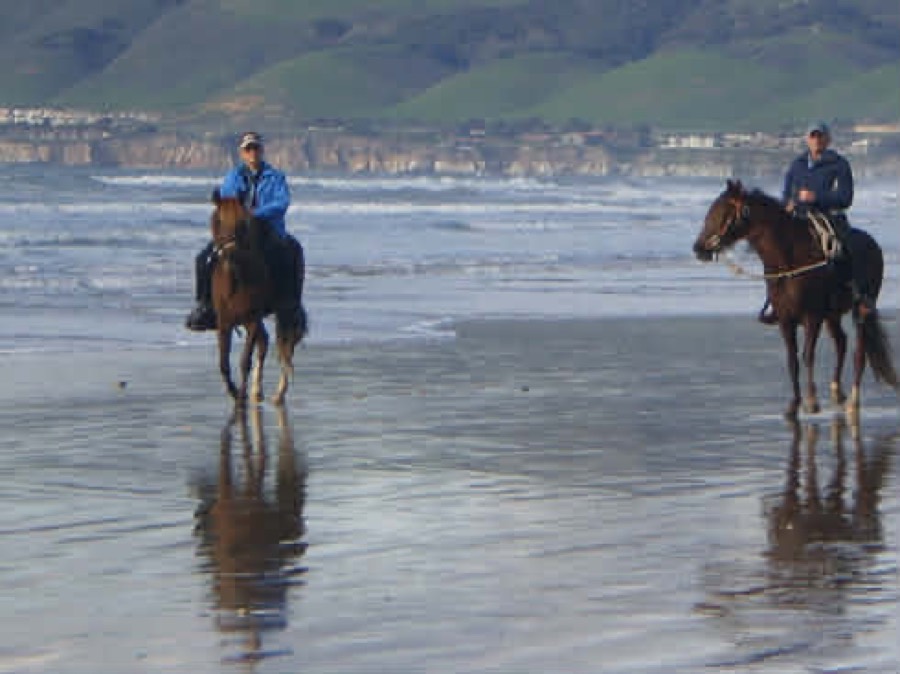 Horseback riders on the beach