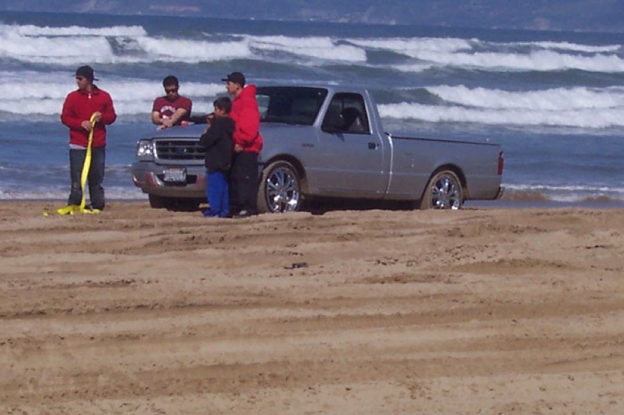 Lowered two wheel drive truck stuck in the sand