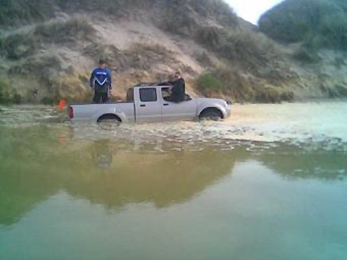 Pickup truck stuck in the flooded Arroyo Grande Creek