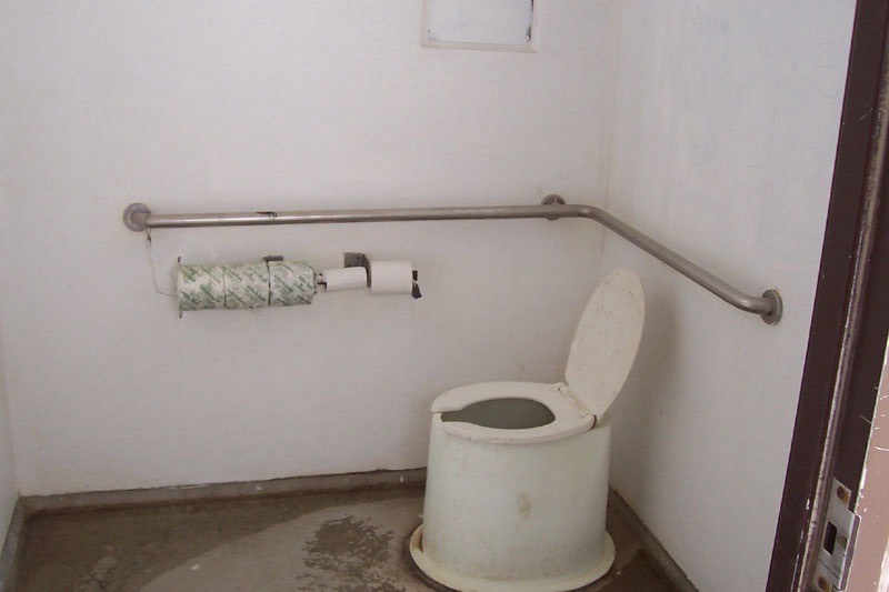 Interior of a vault toilet restroom